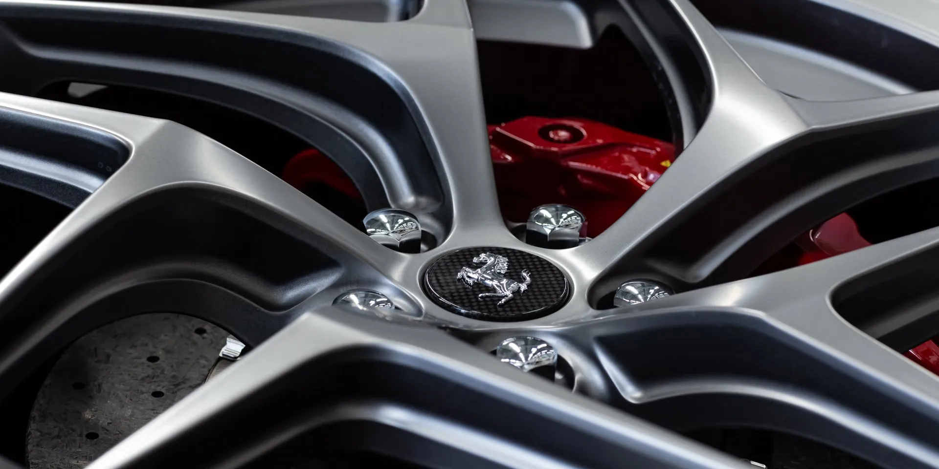 Ceramic coated wheel and red brake caliper at Metropolitan Detail in Redmond